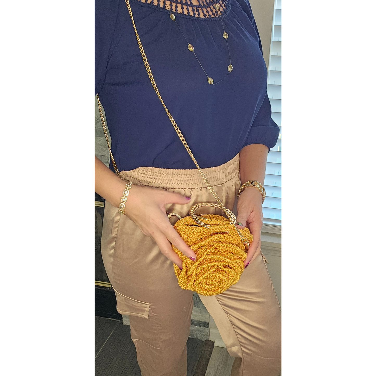 Model showcasing Gold Rosa Bloom Macramé Crossbody – handmade 3D rose design bag, lightweight macramé craftsmanship with gold chain strap, perfect for Mother's Day, weddings, and summer outfits.