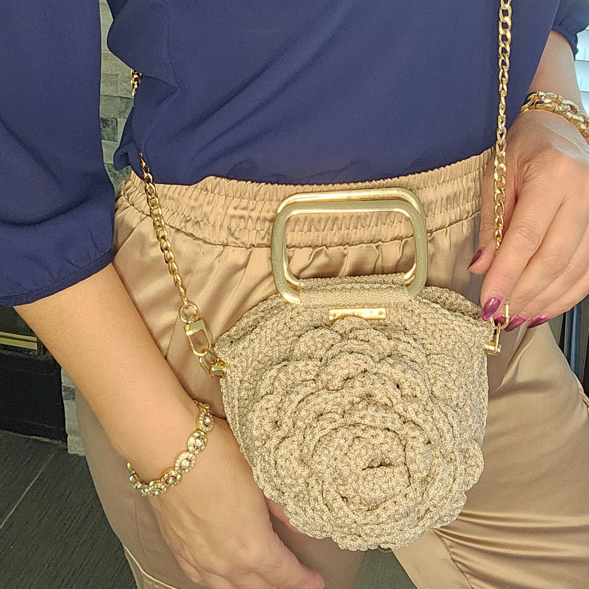 Fashion model showcasing Petite Spiral Bloom Macramé Tote – Handmade mini floral purse, perfect for elegant styling and gifting.