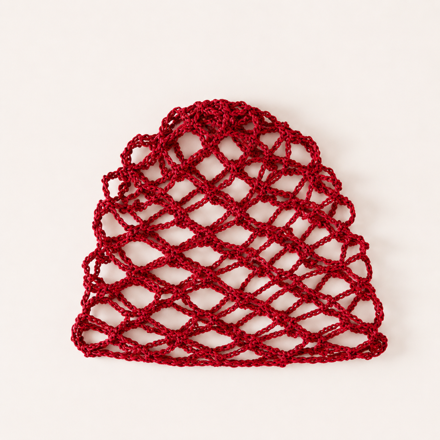 Red handmade mesh crochet cap by Rita Rosa Brazilian Beachwear with open fishnet crochet design and boho festival aesthetic.