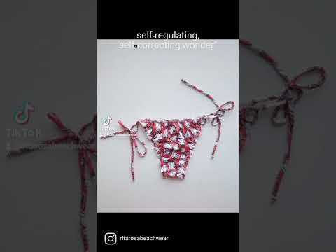 Woman wearing a cajun print bikini set with tie straps, ruffled details, and neck ties, perfect for a stylish and comfortable day at the beach or pool.