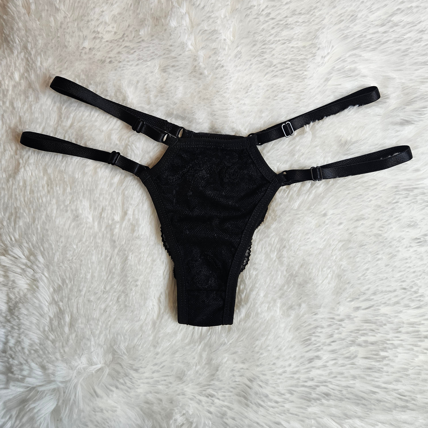 Front view of black Brilho Strappy Lace G-String and adjustable four-strap. system.