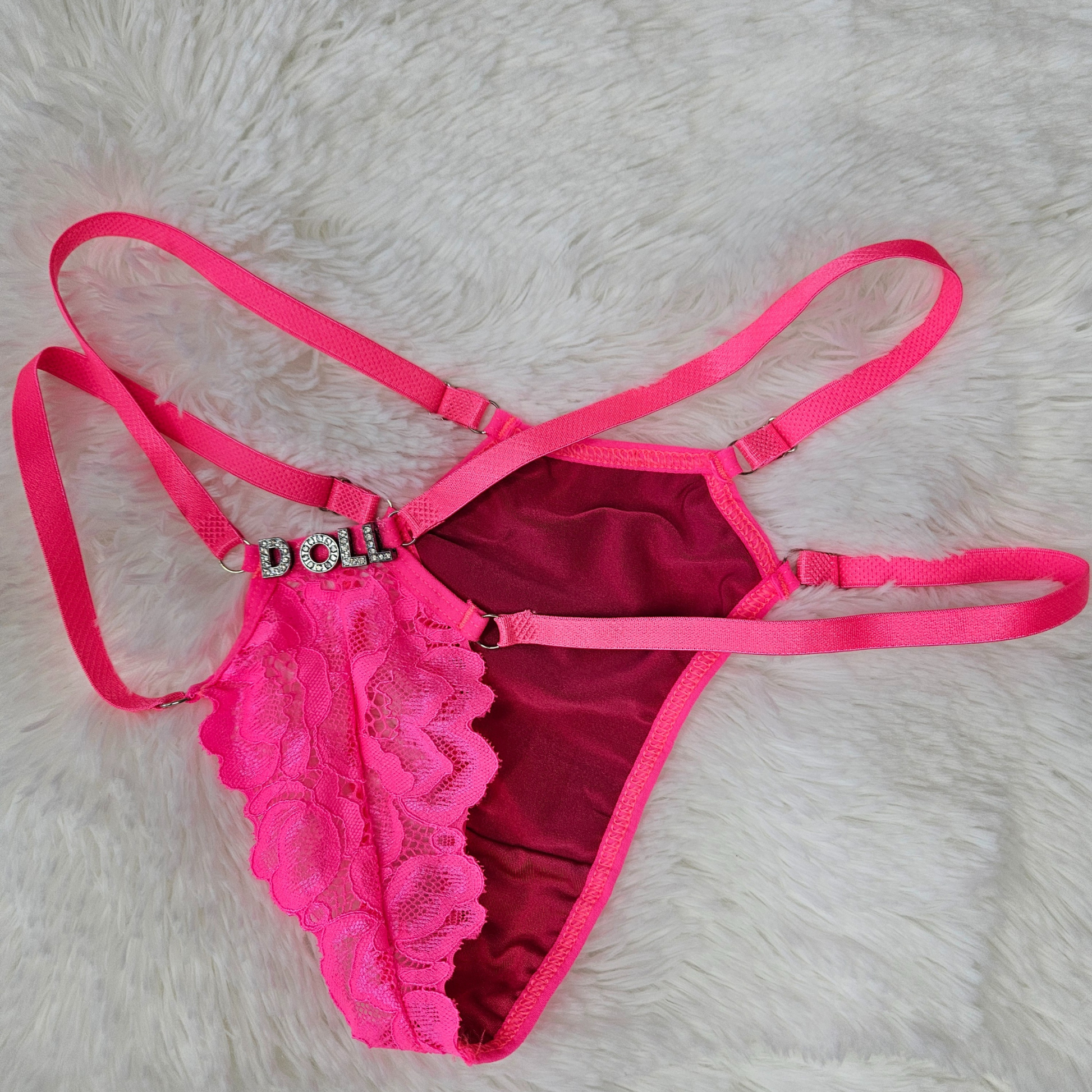 Boutique pink floral lace G-string with a DOLL rhinestone statement and signature gold-toned adjustable sliders
