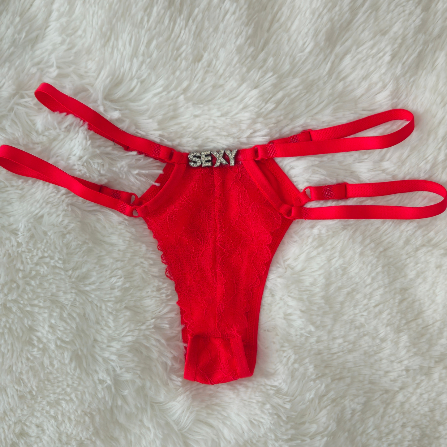 Limited edition red strappy lace G-string from the Brilho collection with SEXY crystal hardware and architectural double-strap design.