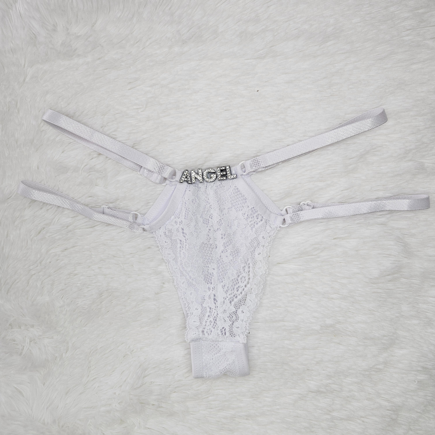 Brilho Adjustable Strappy Lace G-String in White featuring a hand-set ANGEL rhinestone statement and four satin adjustable straps.