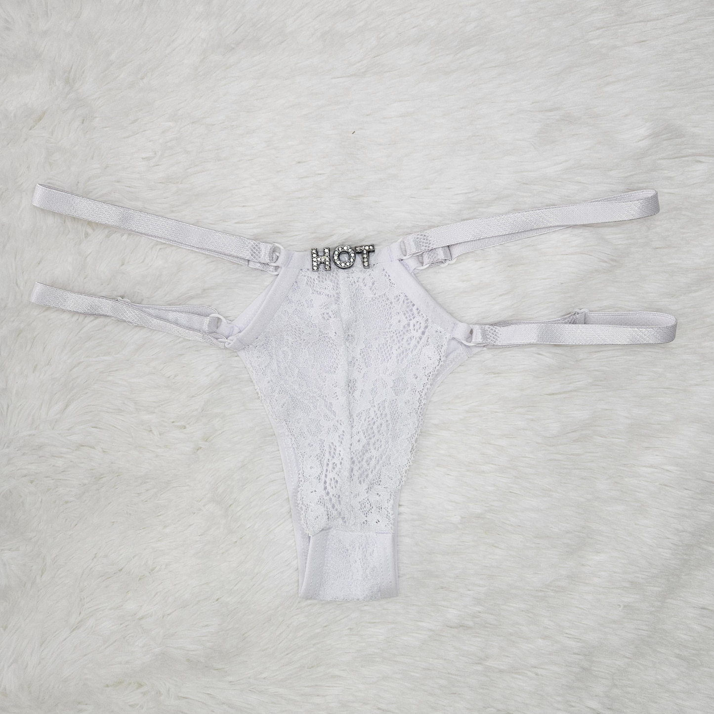 Brilho Adjustable Strappy Lace G-String in White featuring a hand-set HOT rhinestone statement and four satin adjustable straps.