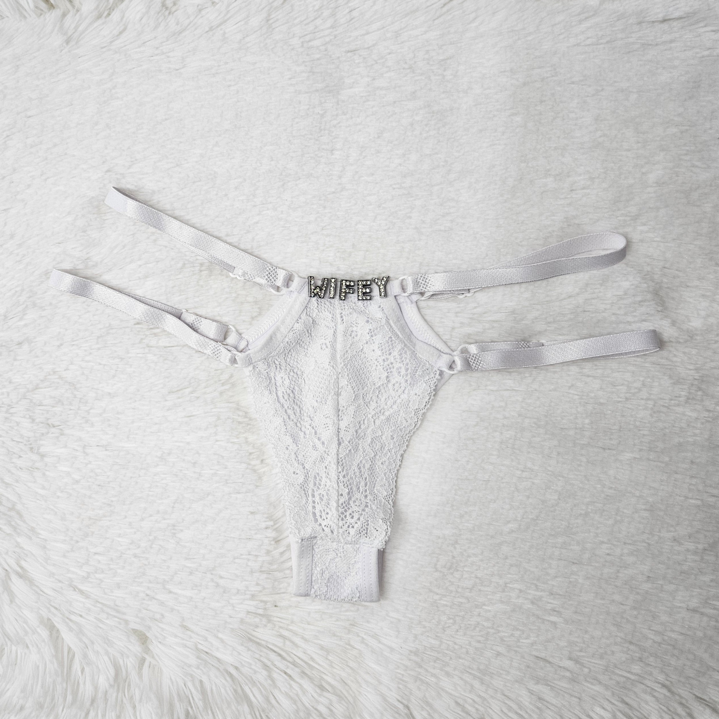Brilho Adjustable Strappy Lace G-String in white featuring a hand-set WIFEY rhinestone statement and four satin adjustable straps.