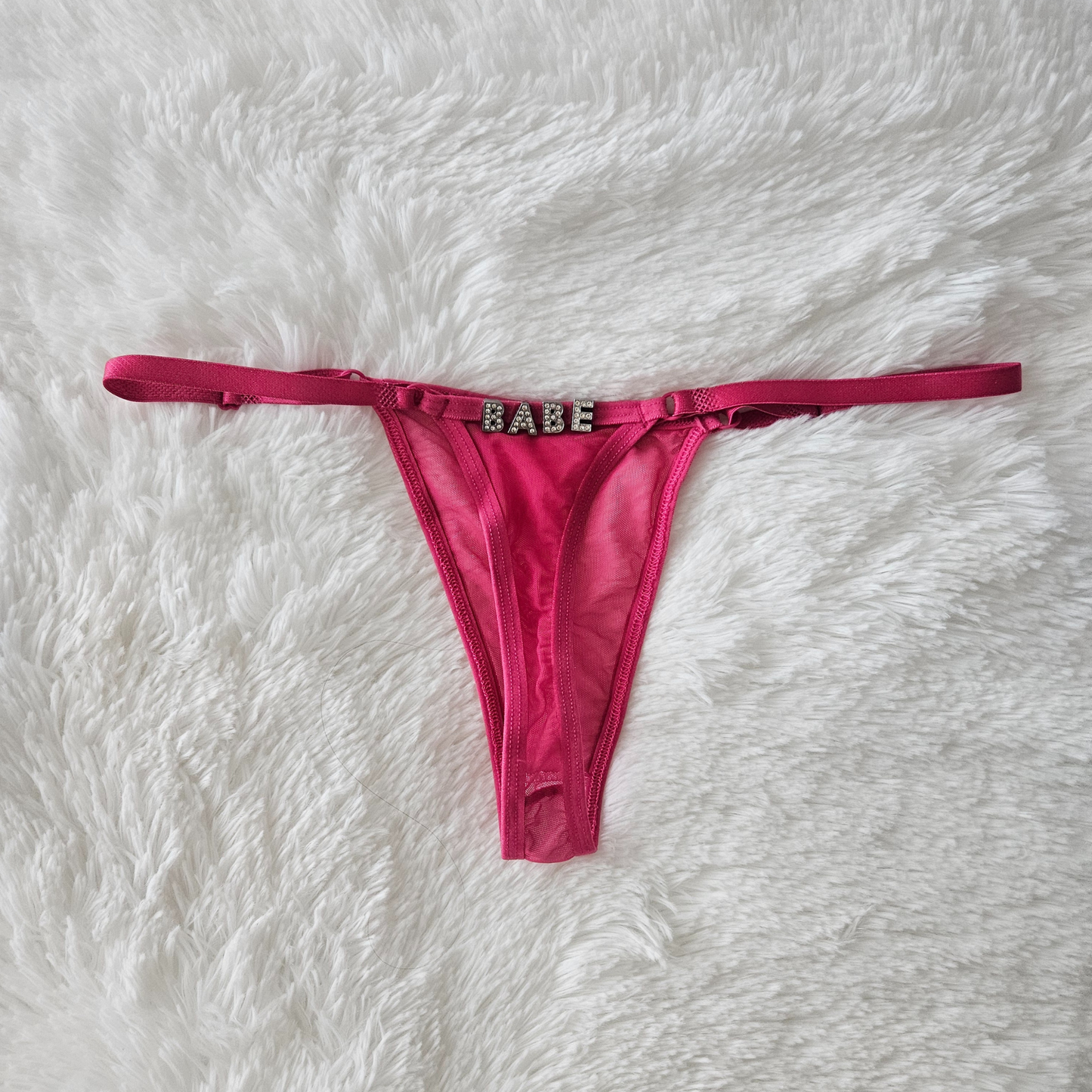 Pink sheer Brazilian mesh G-string with hand-applied BABE rhinestone statement.