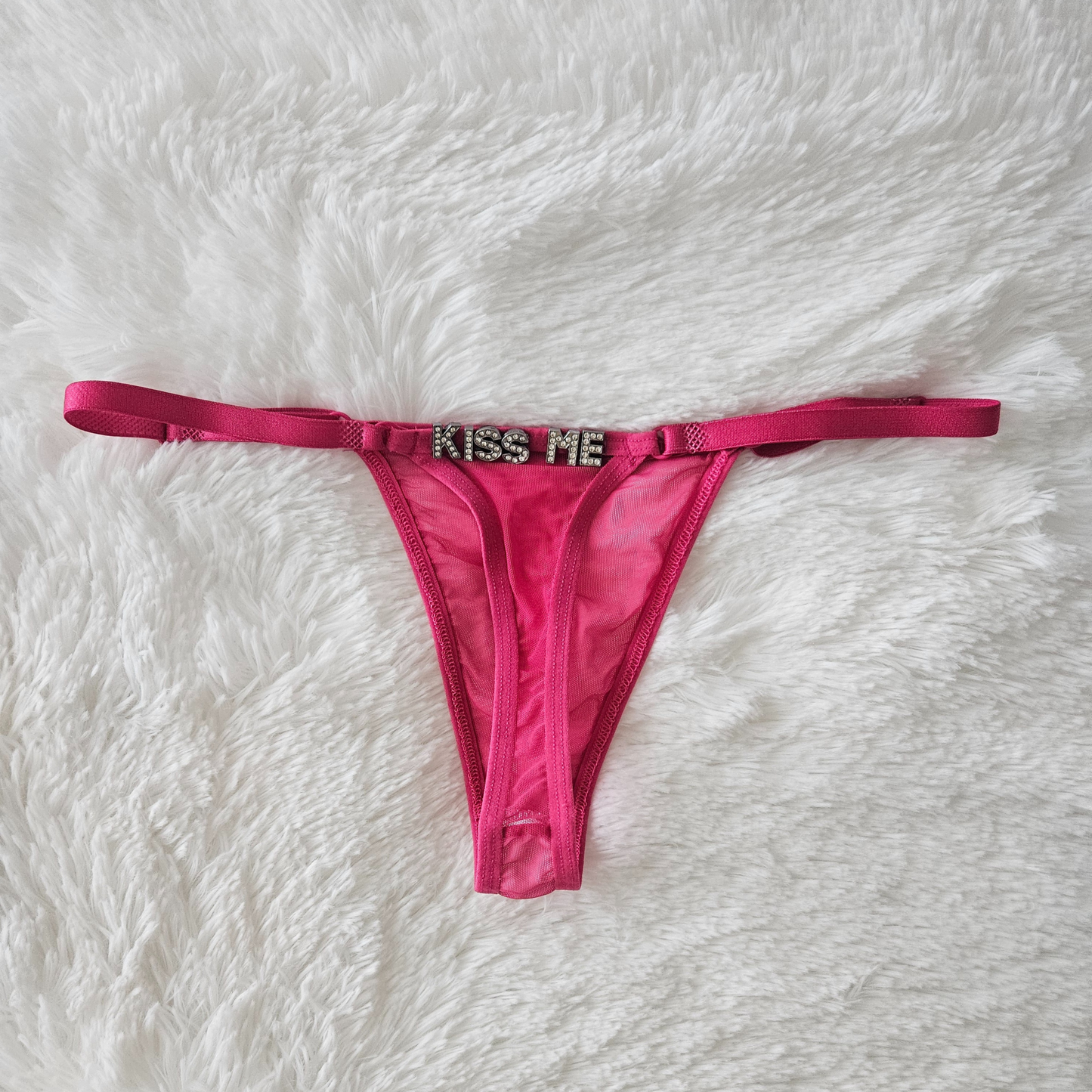 Pink sheer Brazilian mesh G-string with hand-applied KISS ME rhinestone statement.