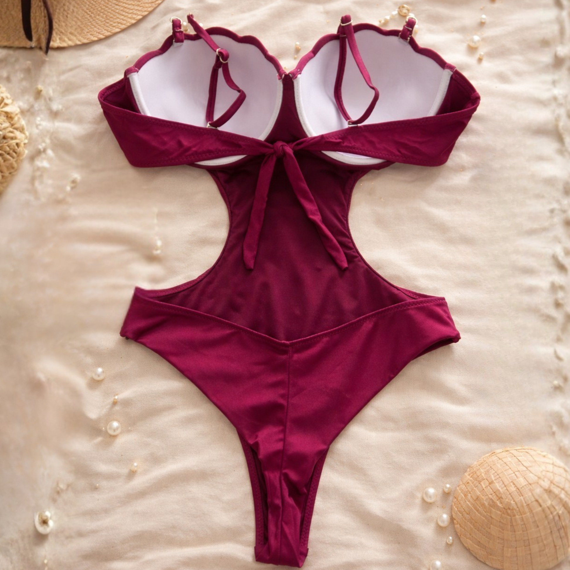 Hot pink Brazilian one-piece swimsuit back view with tie bow and pearl straps, cheeky cut