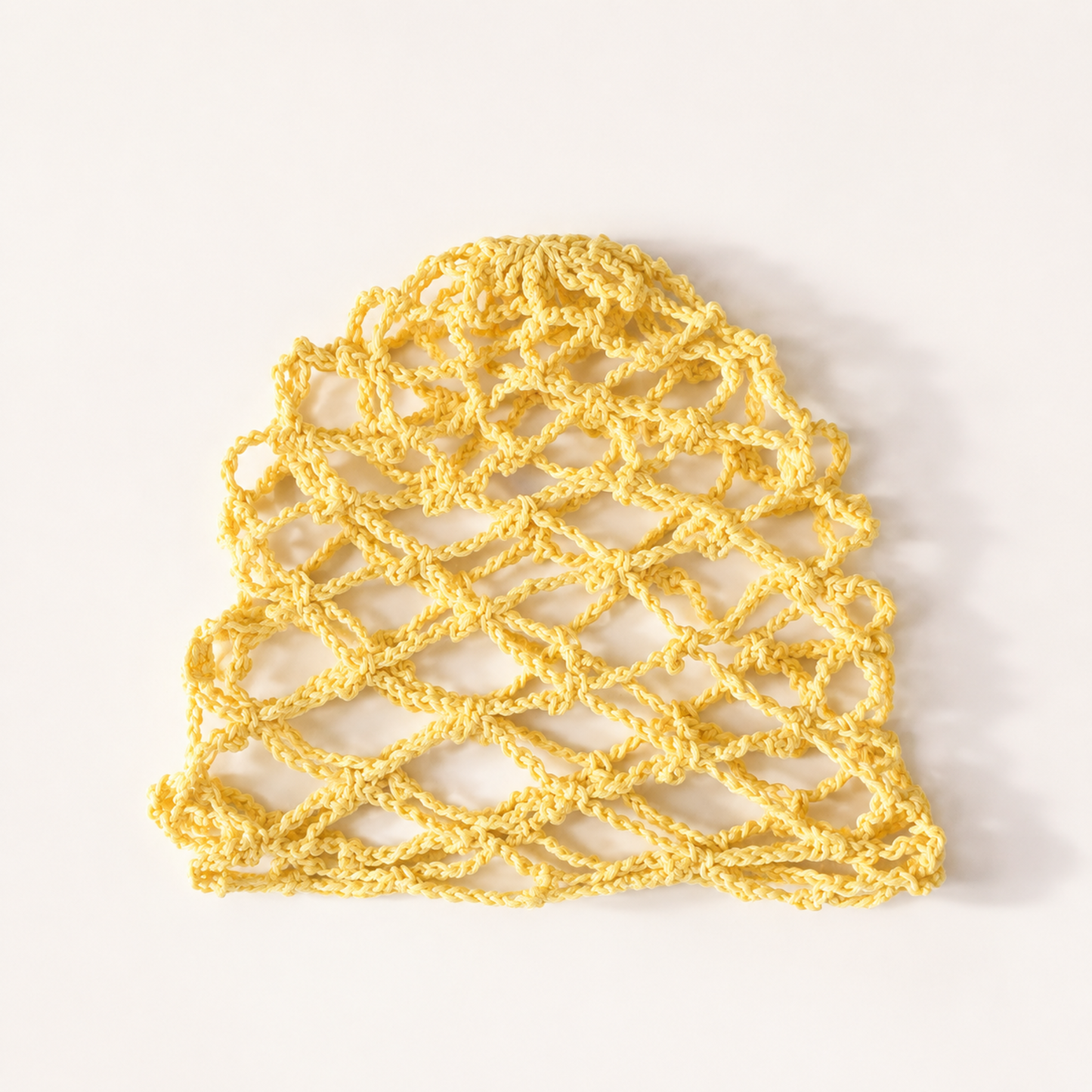Yellow handmade mesh crochet cap by Rita Rosa Brazilian Beachwear with airy fishnet crochet pattern for beach and music festival fashion.