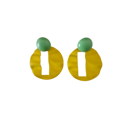Pair of earrings with green tops and yellow bottoms on a white background