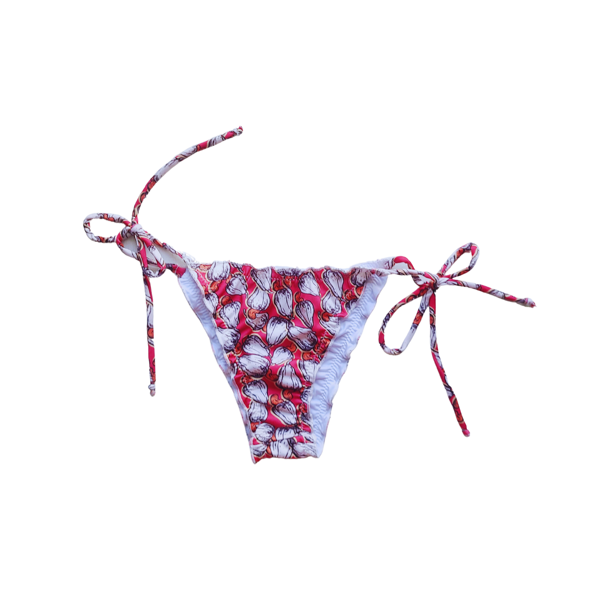 Woman wearing a cajun print bikini set with tie straps, ruffled details, and neck ties, perfect for a stylish and comfortable day at the beach or pool.